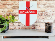 Load image into Gallery viewer, Flag Clock, Shield Shape Featuring The St George's Flag of England, With ENGLAND across the Middle, 2 Sizes Available, Battery Included