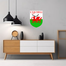 Load image into Gallery viewer, Flag Clock, Shield Shape Featuring The Flag of Wales, With CYMRU across the Top, 2 Sizes Available, Battery Included