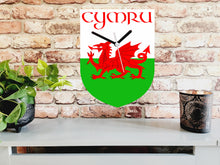 Load image into Gallery viewer, Flag Clock, Shield Shape Featuring The Flag of Wales, With CYMRU across the Top, 2 Sizes Available, Battery Included